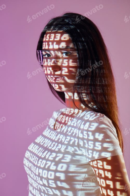 Preview: Different numbers. Beautiful young woman is in projector neon lights in the studio