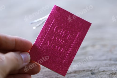 Preview: People holding pink gift card decoration in hand closeup blur background