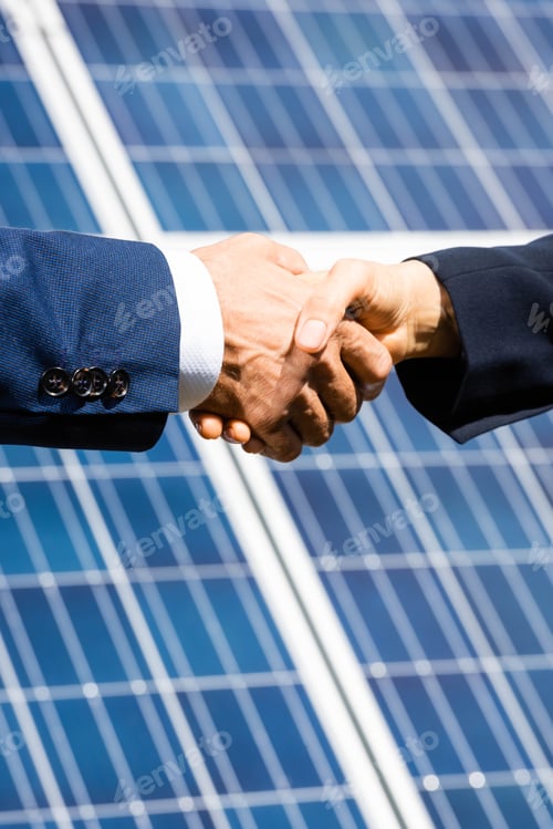 Preview: cropped view of businessman and businesswoman shaking hands outside