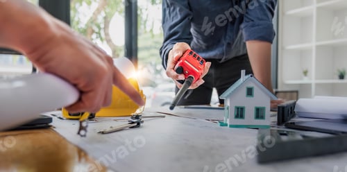 Preview: Civil engineer teams meeting working together wear worker helmets hardhat on construction site in