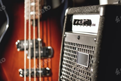 Preview: Just perfect sound. Close up view of a brown electric guitar and amplifier standing in audio