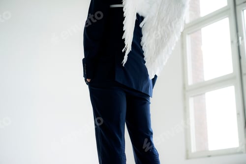 Preview: Businessman wearing suit and angel's wings, rear view