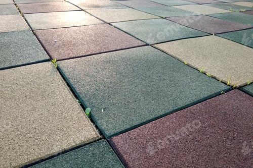 Preview: Close up of soft rubber tiles for covering at outdoor gym of stadium at preschool yard.