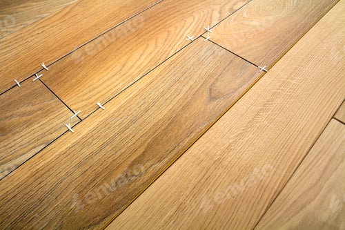 Preview: Natural light brown wooden parquet floor boards. Sunny soft yellow texture, copy space perspective