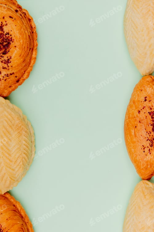 Preview: top view of bakery products as shakarbura and badambura on sides on green background with copy space