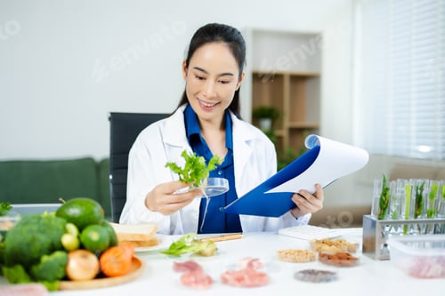 Preview: Nutritionist in safety goggles analyzing kale and vegetables in a food science lab. Health, diet,