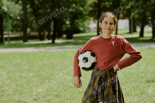 Preview: Portrait of Teenage Boy Holding Soccer Ball in Park Outdoors
