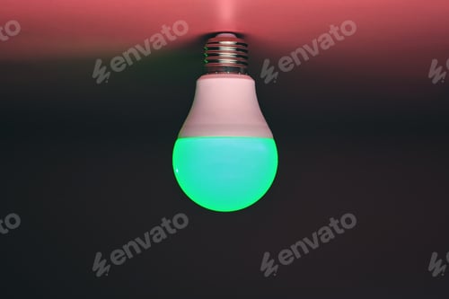 Preview: Energy saving light bulb, green light glowing, copy space. Minimal idea concept.
