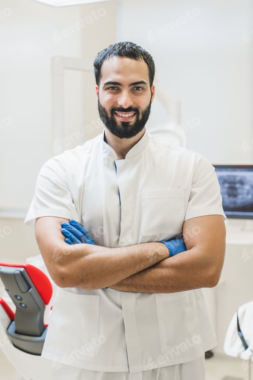 Preview: Stomatologist dentist with arms crossed looking at camera at dental orthodontic clinic hospital