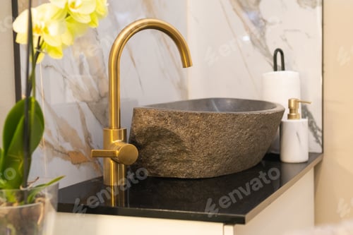 Preview: Stone washbasin and golden faucet