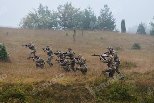 Preview: A disciplined and specialized military unit, donned in camouflage, strategically patrolling and