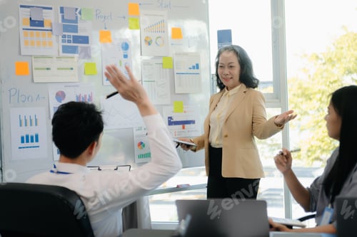 Preview: The boss stands near the board with graphs, demonstrates statistics, various personnel attending