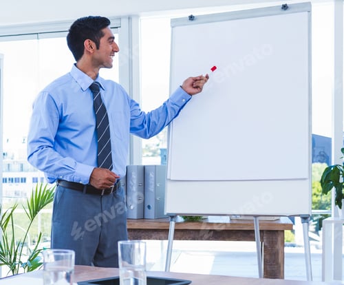 Preview: Presenting on whiteboard, business professional leading meeting in modern office