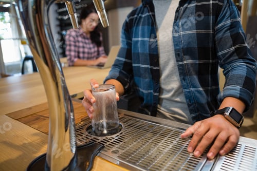 Preview: Midsection of bartender preparing drink