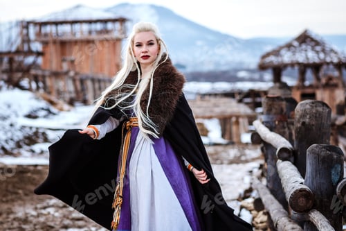 Preview: Beautiful young woman holding a viking with blond hair. Image of Historical figure