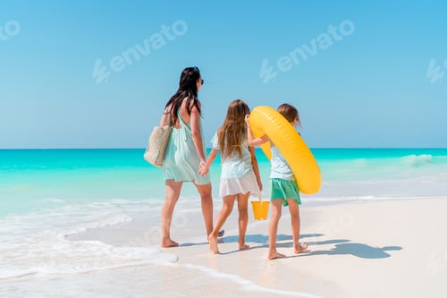 Preview: Beautiful mother and her adorable little daughter at beach