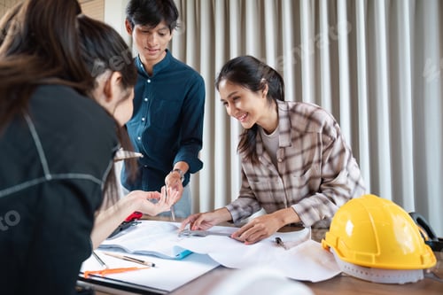 Preview: Construction professionals collaborating over blueprints and project plans.