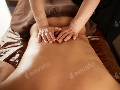 Preview: Asian man receiving a waist massage
