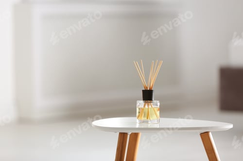 Preview: Aromatic reed air freshener on table against blurred background