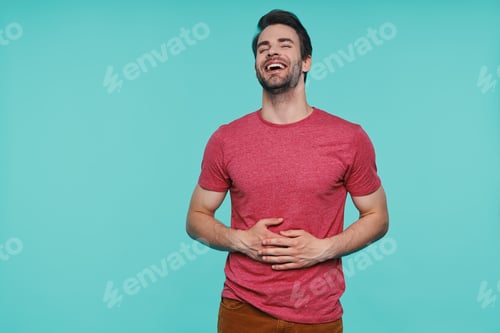 Preview: Handsome young man in casual clothing keeping eyes closed and smiling