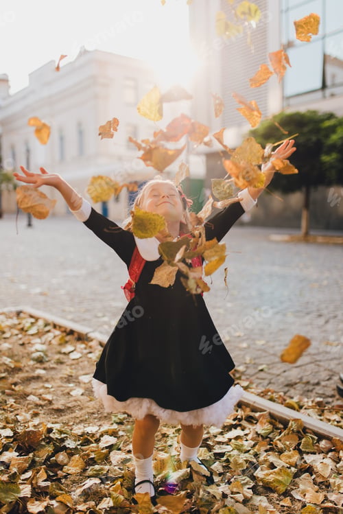 Preview: Little schoolgirl throwing up leaves