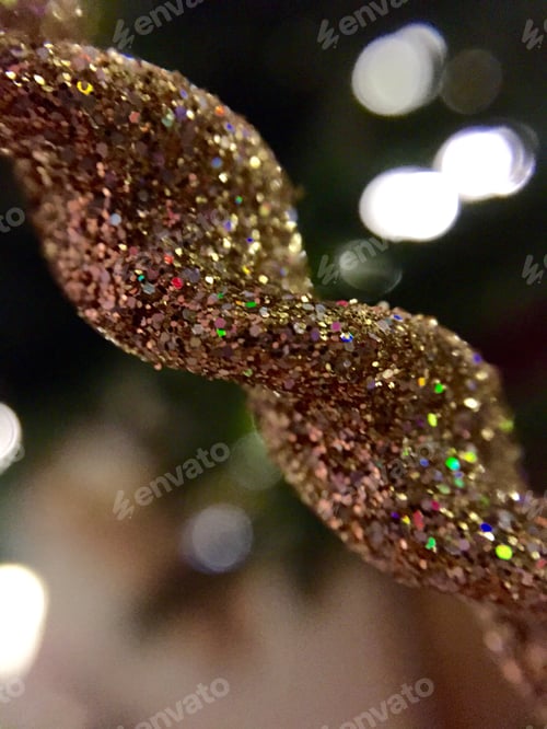 Preview: Closeup of a gold glittery Christmas ornament.