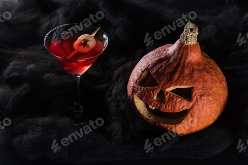 Preview: red decorated Halloween cocktail near spooky pumpkin in black clouds