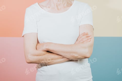 Preview: Old woman standing over isolated and smiling colorful background.