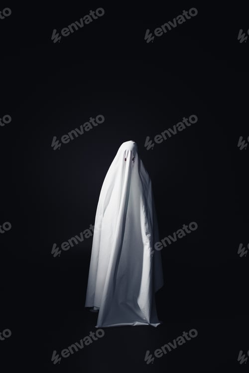 Preview: horrible ghost in white bedsheet isolated on black with copy space