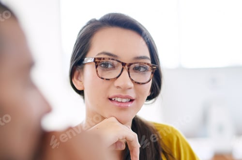 Preview: Listening intently. Portrait of an attractive young woman sitting in a meeting with coworkers.