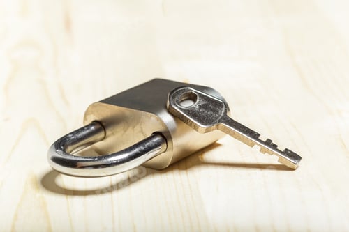 Preview: check-lock on the wooden table background