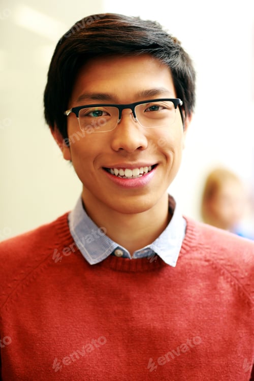 Preview: Portrait of a young happy asian man with glasses