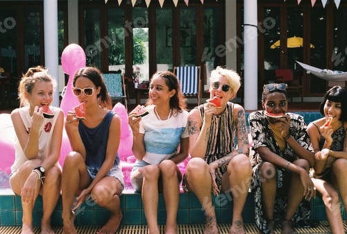 Preview: Group of girls friends eating watermelon at the pool