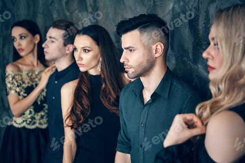 Preview: Group of young beautiful people posing in studio