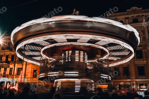 Preview: Children's Carousel in the evening and night illumination. Spinning retro carousel. Merry-go-round a