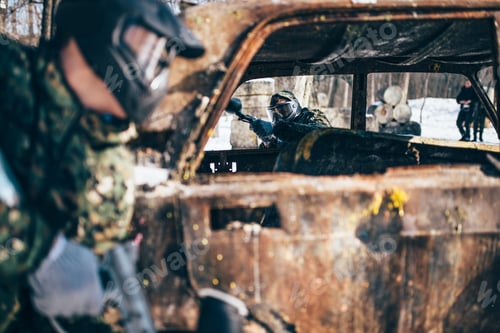 Preview: Paintball battle, players fight around burned car