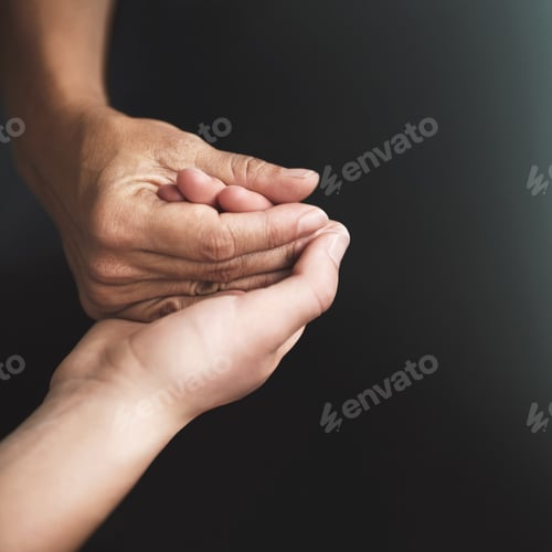 Preview: Love is a verb. Cropped shot of two people holding hands in comfort.