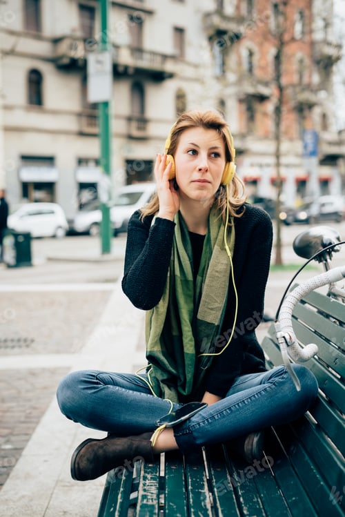 Preview: Woman Listening To Music On City Bench