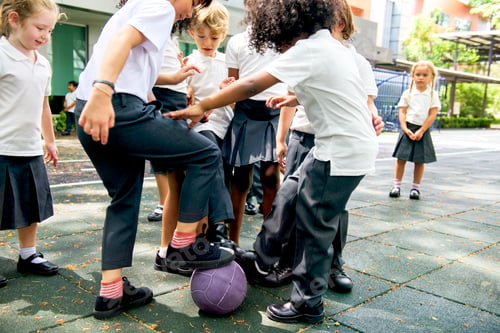 Preview: Group of diverse kindergarten students playing soccer together