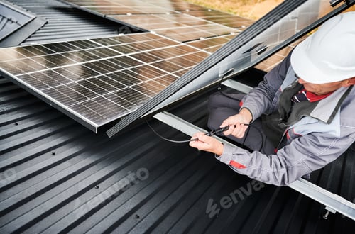 Preview: Professional specialist connecting cables of photovoltaic solar panel.