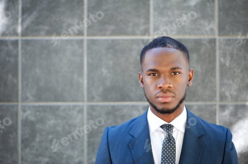 Preview: Handsome businessman on gray background