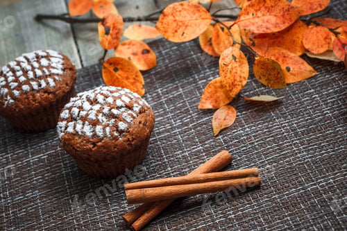 Preview: Chocolate muffins with apple filling on a background of autumn leaves and cinnamon