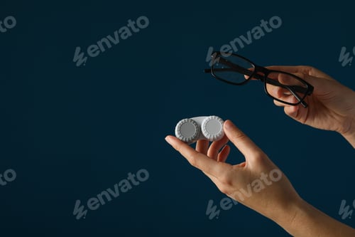 Preview: Glasses and a container for contact lenses in hands