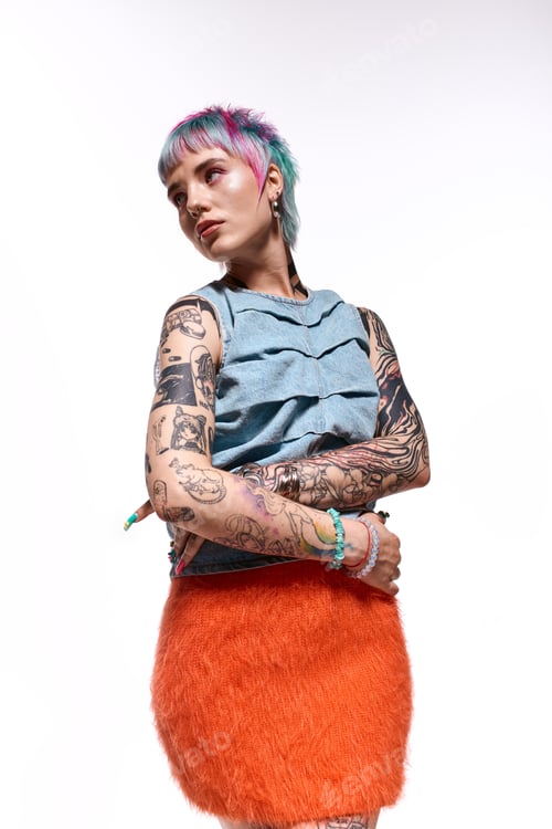 Preview: Young woman showcases vibrant style and tattoo art in a creative studio setting