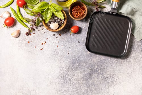 Preview: Food cooking background on gray background with grill pan. Empty grill skillet, vegetables, spices.