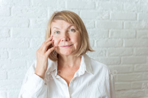 Preview: Sad surprised old mature woman looking at camera worried about facial wrinkles