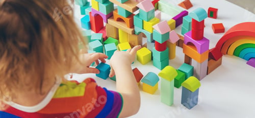 Preview: A child builds from blocks. Selective focus.
