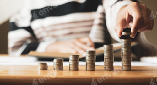 Preview: Woman's hand. Place a coin on the coin graph with coins, saving money with coins, stepping into