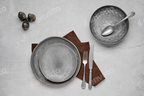 Preview: Set of grey ceramic plates and tableware, top view
