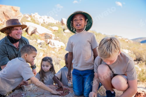Preview: Children at a camp learning from guide